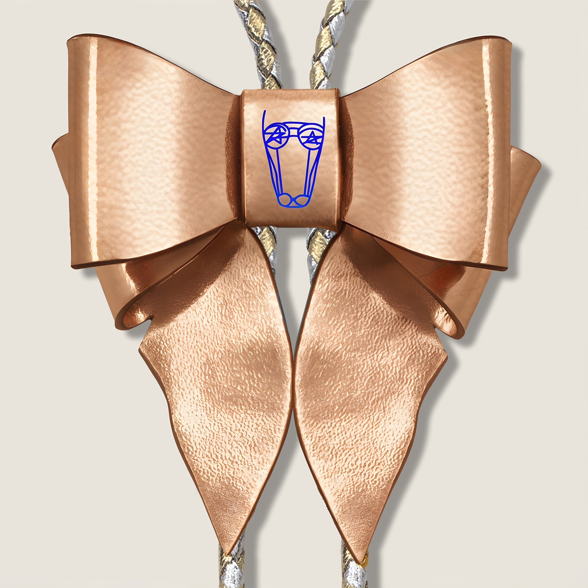 Metallic Copper Leather Bow with central Brand Logo on Beige Background