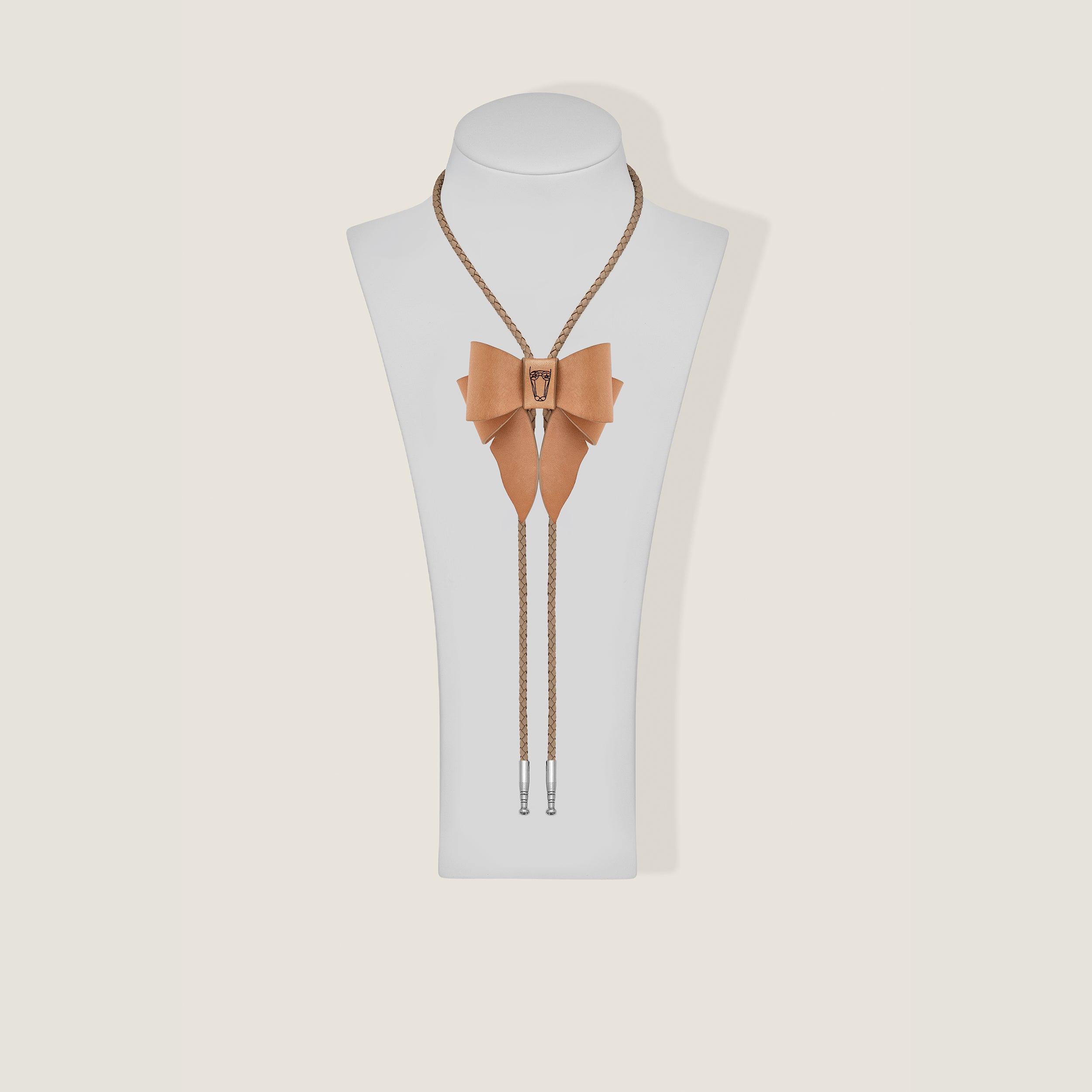 Marrs Makers Tan bow tie and lanyard set on a mannequin bust against a beige background