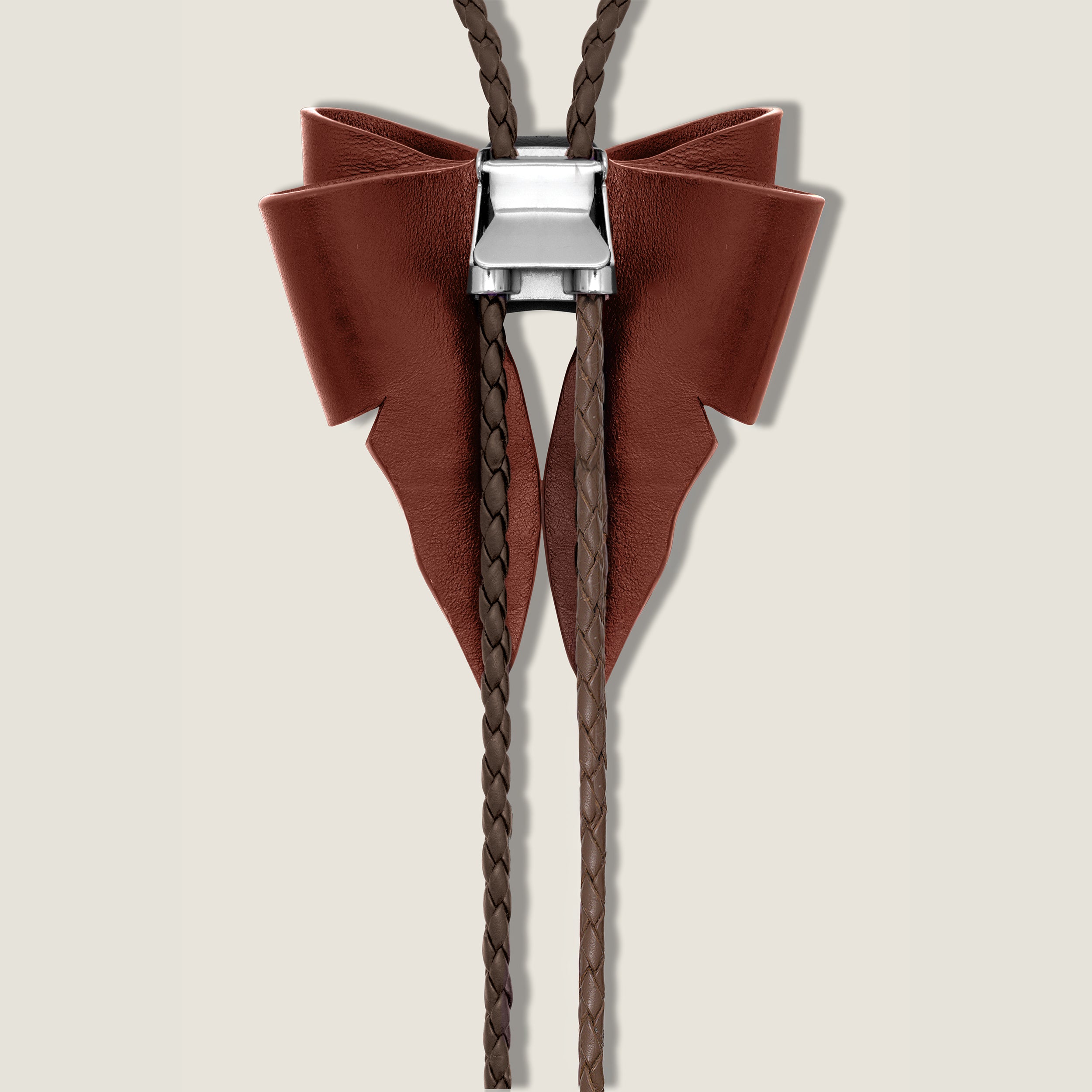 Brown bolo tie with braided leather cord on a beige background