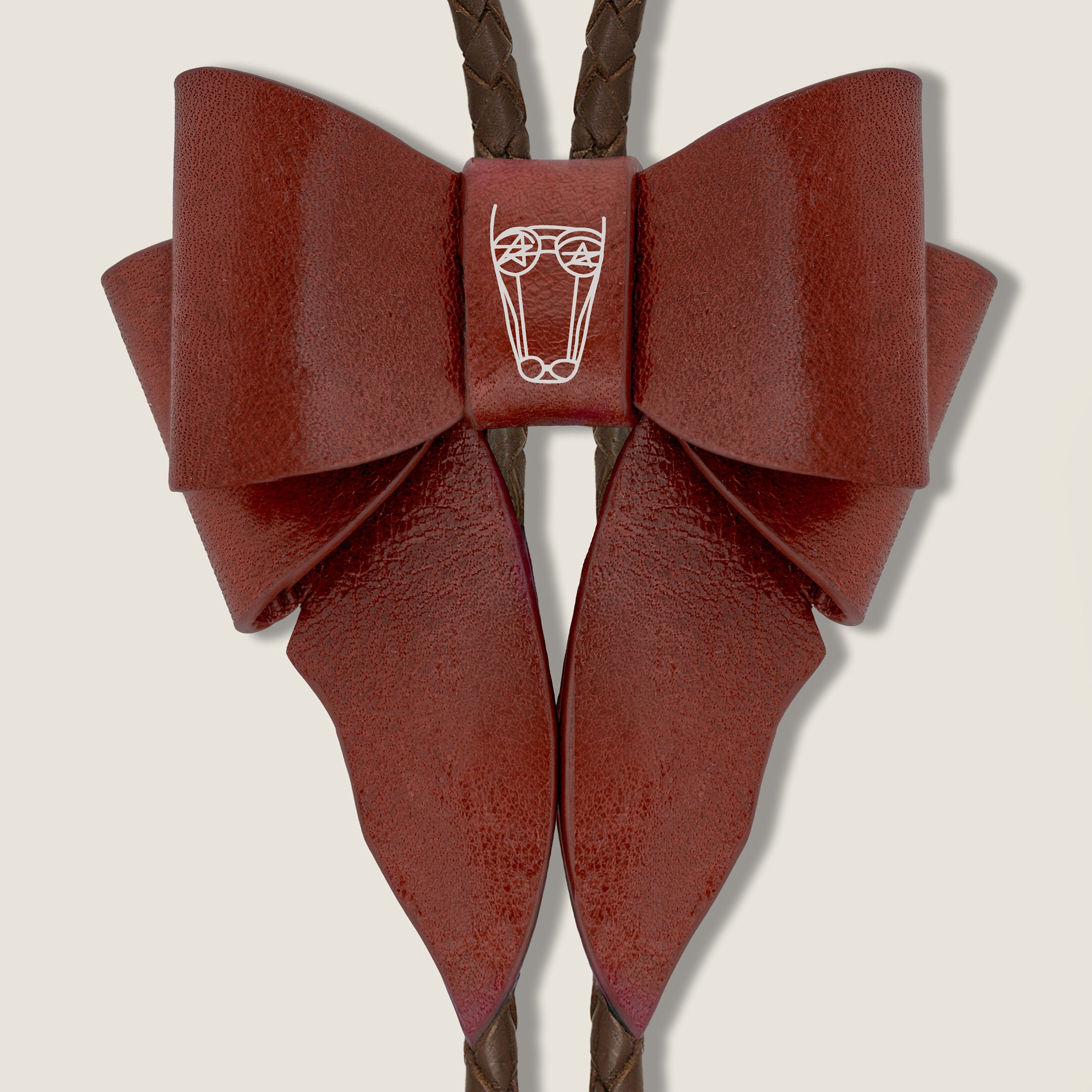 Brown leather bow necklace with a central brand logo on a beige background