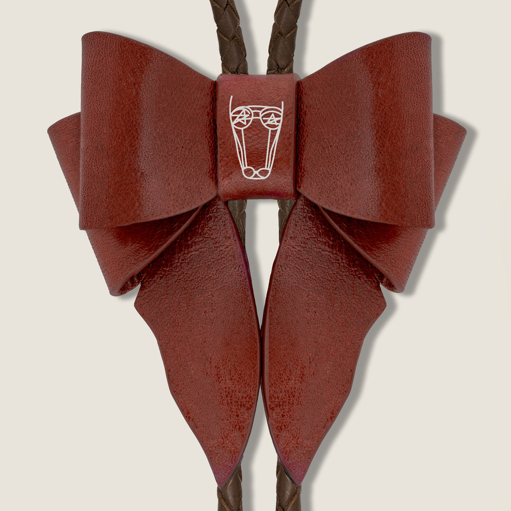 Brown leather bow necklace with a central brand logo on a beige background