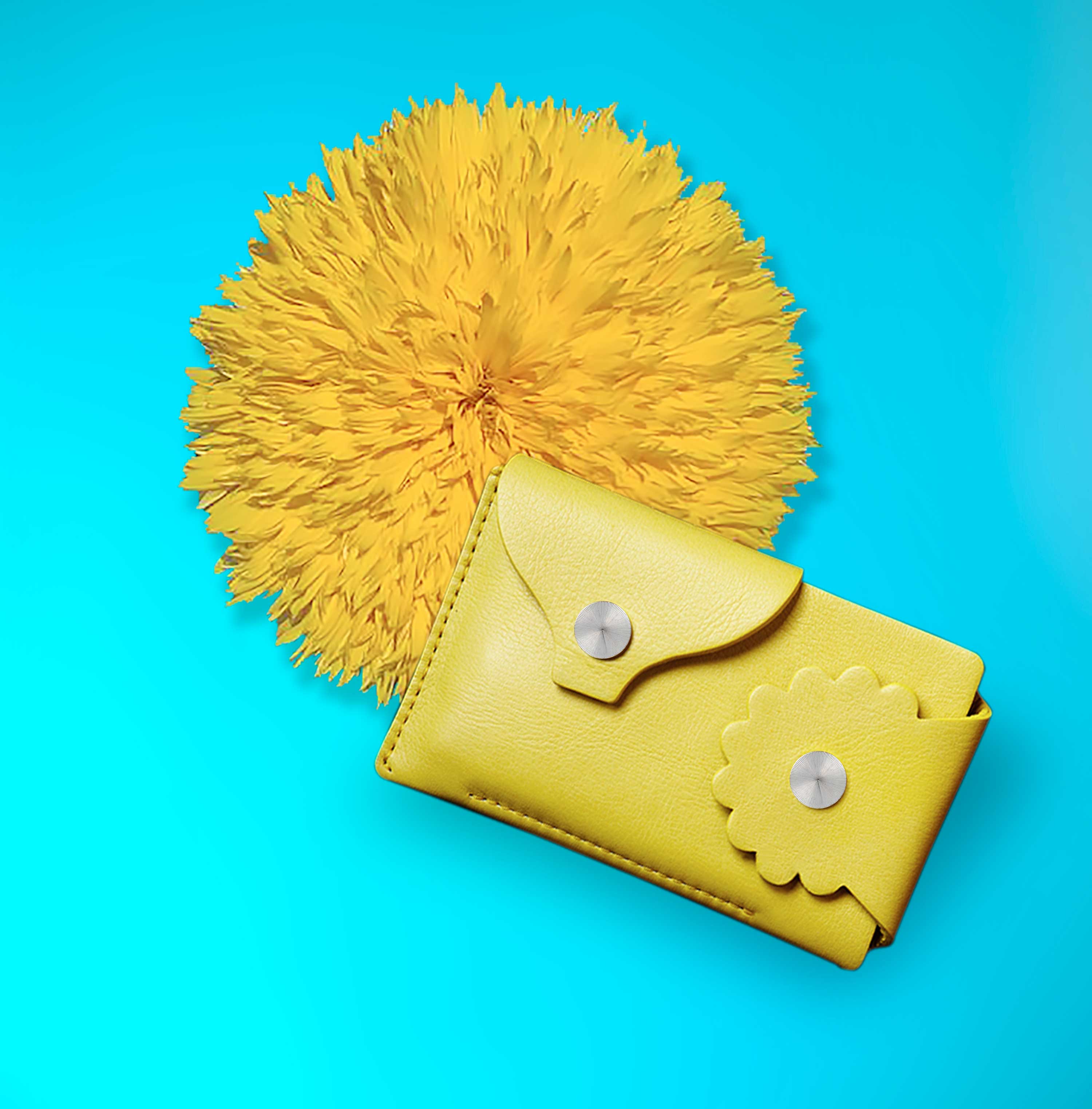Marrs Makers Marigold Yellow Leather Wallet. Bright turquoise background color with large sunflower in this product shot.